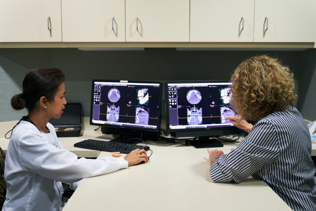 Recent Peak Dental graduate holding her certification